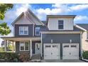 Charming two-story home featuring a two-car garage, covered porch, and professionally landscaped front yard at 706 Fireball Ct, Knightdale, NC 27545