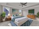 Spacious main bedroom featuring a king bed, contemporary décor, and ample natural light at 706 Fireball Ct, Knightdale, NC 27545