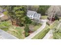 Expansive aerial view of a white home with a long driveway surrounded by lush greenery and trees at 7201 Jonathan Dr, Wendell, NC 27591