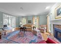 Bright living room with hardwood floors, a fireplace, and a view of the entrance hall at 7201 Jonathan Dr, Wendell, NC 27591