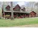 Charming log home with a covered front porch, dormer windows, and a matching two-car garage at 932 Gynnis Creek Dr, Moncure, NC 27559