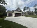 New home featuring a two-car garage, large driveway, and stylish exterior at 104 Roma Gora Ct, Princeton, NC 27569