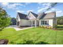 Inviting two-story home showcasing a well-kept lawn, lush landscaping, and an attached garage at 104 Roma Gora Ct, Princeton, NC 27569