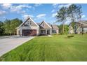Charming two-story home featuring an attached two-car garage, well-manicured lawn, and partial shade at 104 Roma Gora Ct, Princeton, NC 27569