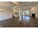 Open-concept living area featuring hardwood floors, a fireplace, and plenty of natural light at 104 Roma Gora Ct, Princeton, NC 27569