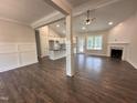 Spacious living room with a view of the kitchen, fireplace, and hardwood floors at 104 Roma Gora Ct, Princeton, NC 27569