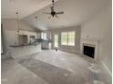 Open-concept living space with a fireplace adjacent to a modern kitchen area at 104 Roma Gora Ct, Princeton, NC 27569