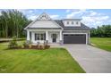 Beautiful two-story home featuring a well-maintained lawn, a garage, and an inviting entrance at 105 Tuskeegee Dr, Smithfield, NC 27577