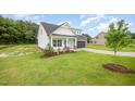Attractive home with a well-kept lawn, stone accents, and a convenient garage at 105 Tuskeegee Dr, Smithfield, NC 27577