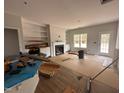 Bright living room featuring built-in shelving, a fireplace, and a view of the backyard at 105 Tuskeegee Dr, Smithfield, NC 27577