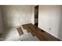 Room with diamond accent wall and wood flooring being installed at 105 Tuskeegee Dr, Smithfield, NC 27577