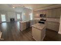 Open kitchen with granite countertops, stainless steel appliances, and an adjacent living area at 106 Roma Gora Ct, Princeton, NC 27569