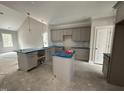 Kitchen featuring gray cabinets, kitchen island, and pendant lighting at 106 Roma Gora Ct, Princeton, NC 27569
