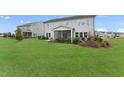 Spacious backyard featuring lush green grass and a charming screened porch at 108 E Fountainhead Ln, Garner, NC 27529