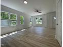 Inviting living room with large windows, hardwood floors, and neutral decor at 112 Remington Woods Dr, Wake Forest, NC 27587