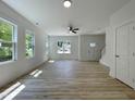 Bright living room with natural light, hardwood floors, and a ceiling fan at 112 Remington Woods Dr, Wake Forest, NC 27587