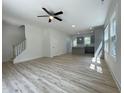 Open-concept living space with a view of the modern kitchen at 112 Remington Woods Dr, Wake Forest, NC 27587