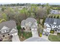 Aerial view of an upscale neighborhood showcasing the home's location with mature trees and manicured lawns at 113 Woodland Ridge Ct, Cary, NC 27519