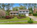 Charming two-story home featuring well-maintained landscaping and a welcoming front porch at 1205 Country Ridge Dr, Raleigh, NC 27609