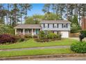 Charming two-story home featuring well-maintained landscaping and a welcoming front porch at 1205 Country Ridge Dr, Raleigh, NC 27609