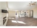 Bright living room with an open-concept layout, modern fireplace, and wood flooring at 122 Wilderness Trl, Smithfield, NC 27577