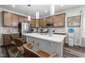 Modern kitchen featuring stainless appliances, a tile backsplash, sleek cabinets, and a large island with sink at 1241 White Flint Cir, Durham, NC 27703
