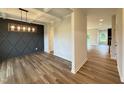Bright dining room featuring wood floors, a decorative accent wall, and a coffered ceiling at 125 Tuskeegee Dr, Smithfield, NC 27577