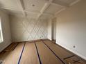Bright living room featuring decorative wall trim, coffered ceiling and natural light at 125 Tuskeegee Dr, Smithfield, NC 27577