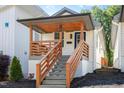 Charming home featuring a covered porch with wooden railings, and well manicured landscaping, creating a welcoming curb appeal at 13 St Augustine, Raleigh, NC 27610