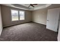 Spacious main bedroom with carpet and a tray ceiling offering comfort and style at 131 Wilderness Trl, Smithfield, NC 27577