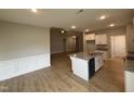 Open kitchen featuring granite counters, a center island with a sink, and seamlessly flowing living spaces at 139 Red River Dr, Selma, NC 27576