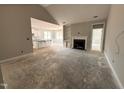 Living room featuring a fireplace, and an open floor plan leading to a kitchen with white cabinets at 139 Red River Dr, Selma, NC 27576