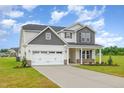 Charming two-story home with a well-kept lawn and extended driveway at 141 Trescott St, Smithfield, NC 27577