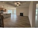 Open-concept living area with a fireplace, coffered ceilings, and seamless transition to the modern kitchen at 141 Trescott St, Smithfield, NC 27577