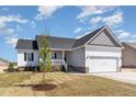Attractive single-story home boasts a well-maintained lawn and inviting covered porch at 143 Royal Ave, Selma, NC 27576