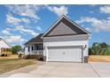 Charming single-Gathering home with a two-car garage and covered front porch at 143 Royal Ave, Selma, NC 27576