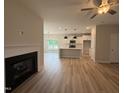 Bright living space featuring a cozy fireplace and views into the modern kitchen at 147 Tuskeegee Dr, Smithfield, NC 27577
