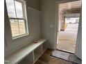Well-lit mudroom with a bench, cubbies, and easy access to the garage at 147 Tuskeegee Dr, Smithfield, NC 27577