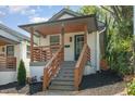 Lovely single Gathering home featuring a cozy front porch with wood railing and glass-paneled front door at 15 St Augustine, Raleigh, NC 27610