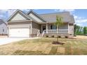 Beautiful new home with attached garage, covered porch, manicured lawn, and young shade tree at 163 Royal Ave, Selma, NC 27576