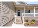 Inviting front porch with brick stairs, white railing, and manicured landscaping at 163 Royal Ave, Selma, NC 27576