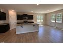 Open kitchen featuring dark cabinets, granite countertops, stainless steel appliances and recessed lighting at 18 Bonnybrook Ct, Selma, NC 27576