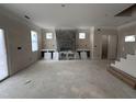 Unfinished living room with large windows, a fireplace mantel, and potential for customization at 18 Bonnybrook Ct, Selma, NC 27576