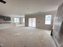 Bright, open living space with sliding glass doors and large windows; ready for personalization at 18 Bonnybrook Ct, Selma, NC 27576