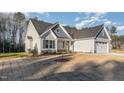 Picture of the home showing the garage, front door, and part of the yard at 18 S Rowsham Pl, Smithfield, NC 27577