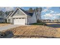 View of the side of the home showing the garage and nice lawn at 18 S Rowsham Pl, Smithfield, NC 27577