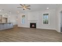 Spacious living room with fireplace, wood floors, and lots of natural light at 18 S Rowsham Pl, Smithfield, NC 27577