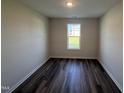 Inviting bedroom filled with natural light, featuring wood flooring and neutral walls at 18 W Emily Gardens Dr, Selma, NC 27576