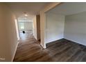 Inviting hallway showcasing luxury vinyl plank flooring and neutral paint at 18 W Emily Gardens Dr, Selma, NC 27576