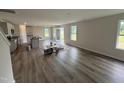 Open-concept living room with hardwood flooring, recessed lighting, and natural light at 18 W Emily Gardens Dr, Selma, NC 27576